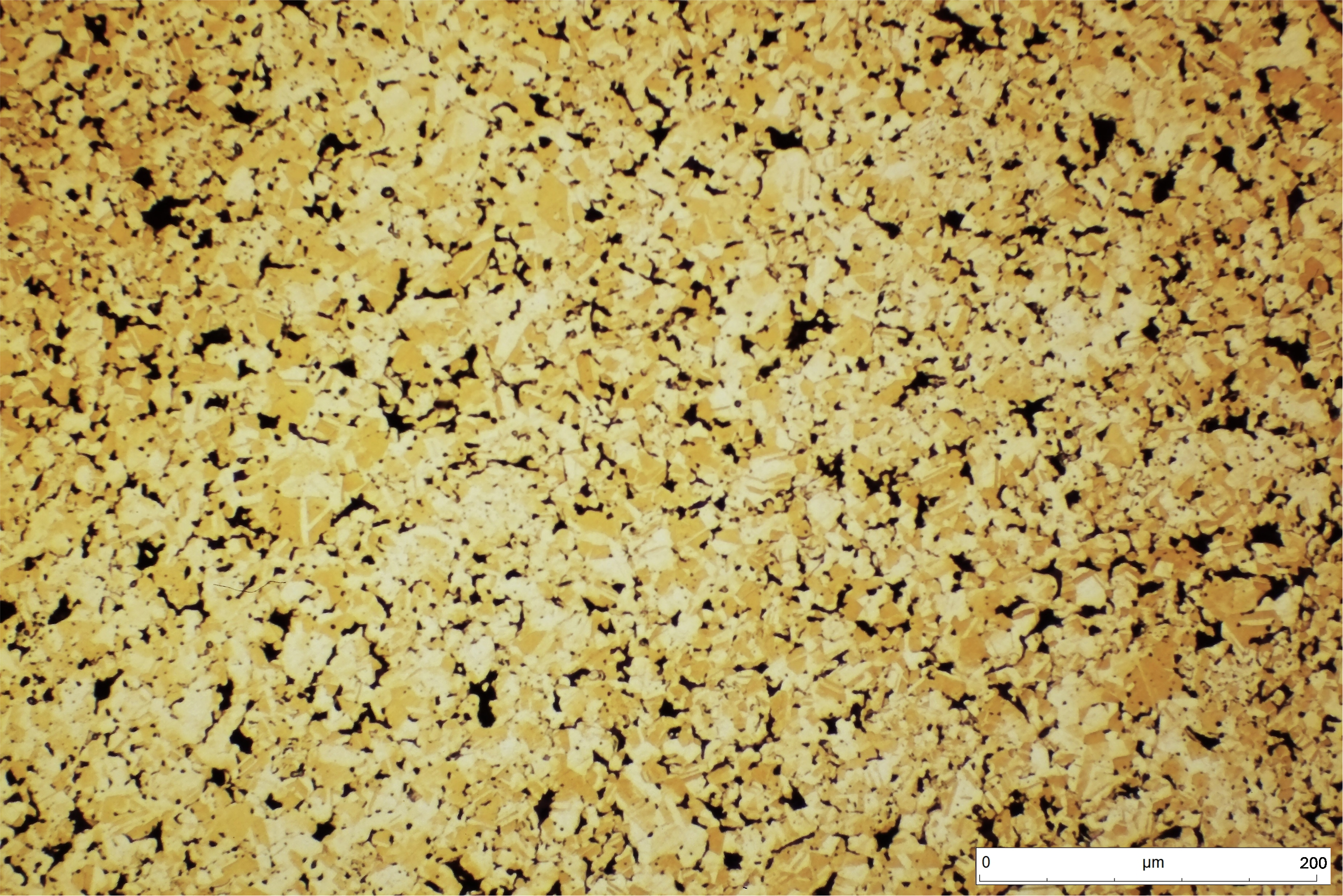 Bronce sinterizado CuSn10. Las partículas sinterizadas sin una total compactación posibilitan la creación de poros donde puede alojarse el lubricante tras un baño en caliente. Durante la fricción, el calentamiento de la pieza libera parcialmente dicho lubricante dotando al material de características autolubricantes. En el enfriamiento, el lubricante es reabsorbido.